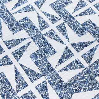 Close-up of a blue and white floral geometric quilt design showcasing The 1751 Quilt Pattern (Download) by Millie & Bun Designs, perfect for intermediate quilters.