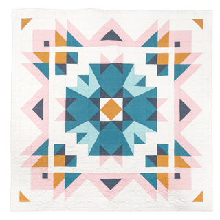 Geometric Aria quilt by Toad & Sew with blue, pink, and orange triangles on a white background