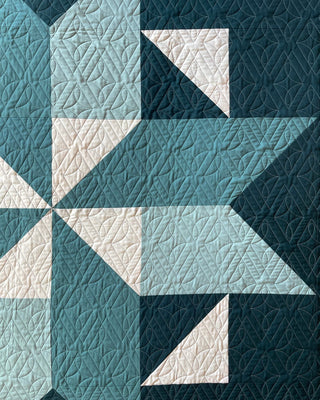 Black Balsam Quilt Pattern by Hampton Quilt Studio closeup: large star block in teal, dark navy, and cream fabrics with detailed quilting texture.