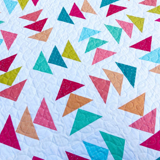 Blessings Quilt Pattern (Download) by Homemade Emily Jane featuring colorful geometric triangle shapes on a soft white quilt background