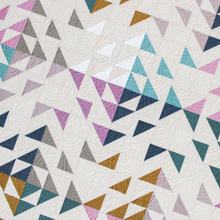 Beyond Quilt by Eudaimonia Studio with geometric triangle pattern in various colors on a white background