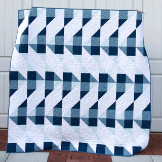 Cirrus Quilt Pattern (Download) by Homemade Emily Jane featuring a modern geometric quilt in navy blue white and soft blue with flowing cloud inspired movement
