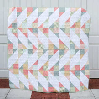 Cirrus Quilt Pattern (Download) by Homemade Emily Jane featuring a modern geometric quilt in soft pastel colors with flowing diagonal shapes.