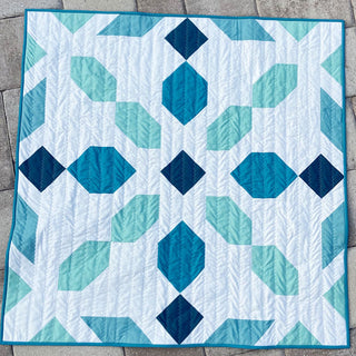 Connector Quilt Pattern (Download) by Homemade Emily Jane featuring a modern geometric quilt in white teal and navy with diamond and leaf shapes