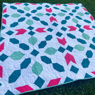 Connector Quilt Pattern (Download) by Homemade Emily Jane, a modern quilt with teal, aqua, and pink geometric shapes on a white background.