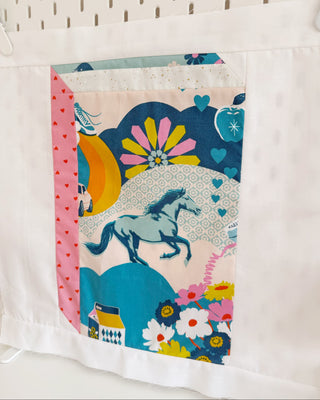 Close-up of a colorful quilt block featuring a running horse and floral patterns, showcasing the Currently Reading Block Pattern (Download) by Lou Orth Designs.