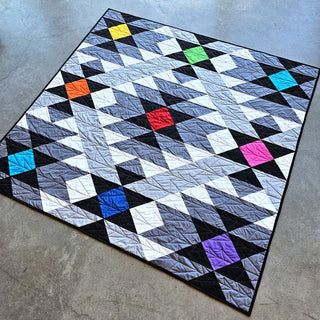 Colorful geometric quilt with bright squares in a modern design by Staci W Quilts, featuring the Desert Chill Quilt Pattern (Download) for an advanced digital quilt pattern.