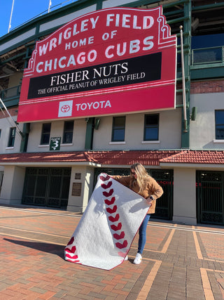 Fastball 2.0 Quilt Pattern (Download) by Jessica Steele Design featuring a modern baseball quilt with red stitching details outside Wrigley Field