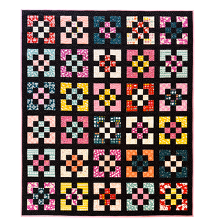 Colorful floral and geometric quilt blocks with black sashing arranged in a grid, showcasing the Front Street Quilt Pattern (Download) by A Piece of Quiet Quilts in a modern style.