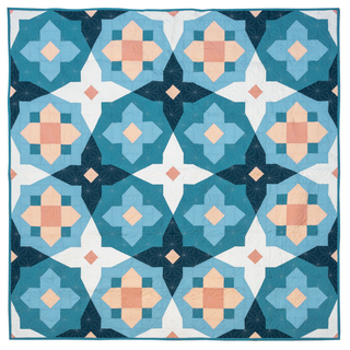 Garden Glow quilt by Toad & Sew with geometric pattern featuring blue, pink, and white colors.