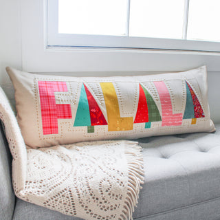 Fa-La-La Quilt Pattern (Download) featuring a festive holiday quilted pillow with colorful stylized trees on a neutral background by Patternly Collective