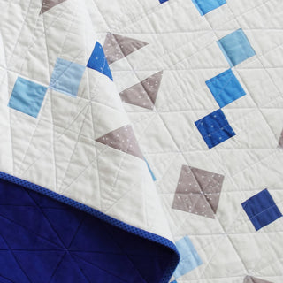 Keystone Quilt Pattern (Download) by Homemade Emily Jane featuring a modern geometric quilt in white blue and taupe with balanced shapes and detailed quilting
