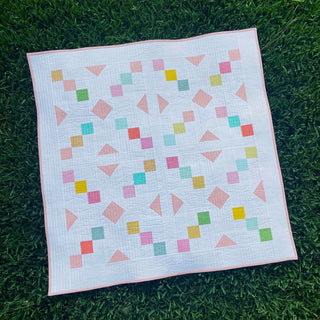 Keystone Quilt Pattern (Download) by Homemade Emily Jane, a modern geometric quilt with pastel pink, teal, yellow, and green shapes on a white background