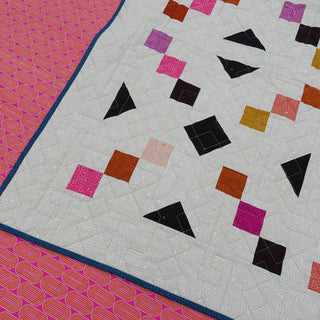 Keystone Quilt Pattern (Download) by Homemade Emily Jane featuring a modern geometric quilt with colorful squares and triangles on a neutral background