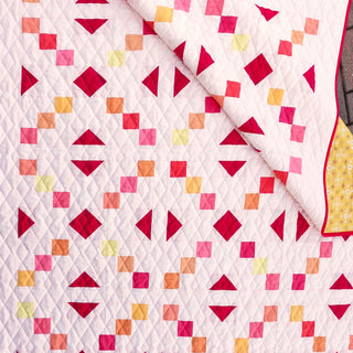 Keystone Quilt Pattern (Download) by Homemade Emily Jane featuring a modern geometric quilt design with colorful symmetrical shapes on a soft white background