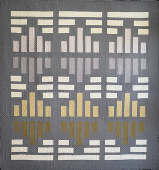 Modern geometric quilt in muted tones of gray, cream, and gold showcasing the Leaded Light Quilt Pattern (Download) by Sewn, perfect for confident beginner quilters.