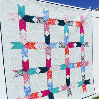 Limelight Quilt Pattern (Download) by Homemade Emily Jane featuring a colorful geometric quilt with bold shapes and textured white negative space
