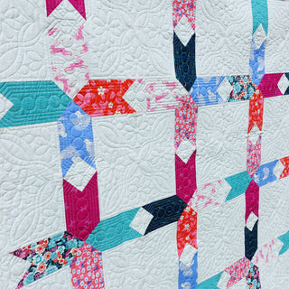 Limelight Quilt Pattern (Download) by Homemade Emily Jane featuring bold geometric shapes colorful fabric accents and intricate white quilting on negative space