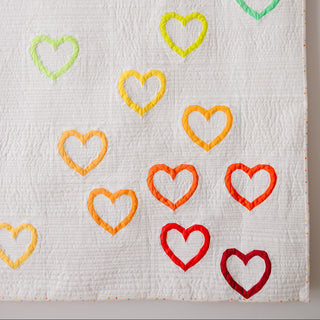 Love FPP Block Pattern (Download) by Aurora + Holly featuring colorful foundation paper pieced heart blocks on a white quilt background.
