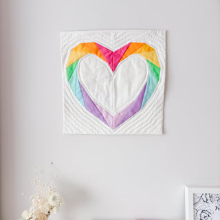 Love FPP Block Pattern (Download) by Aurora + Holly featuring a colorful foundation paper pieced heart quilt block with an open center displayed as wall art