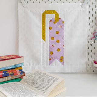 Quilted wall hanging with a bookmark block in gold and purple berry prints by Lou Orth Designs showcasing The Book Block Collection — Complete 5-Block Bundle (Download)
