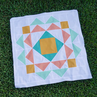 Paradigm Quilt Pattern (Download) modern geometric quilt design in teal coral mustard and white on grass by Homemade Emily Jane