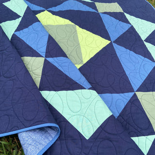 Paradigm Quilt Pattern (Download) by Homemade Emily Jane showing a bold modern geometric quilt in navy blue lime green and aqua with playful angular shapes