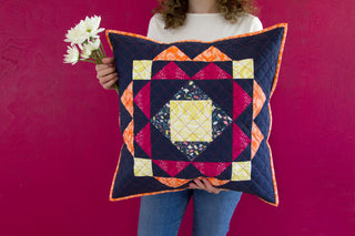 Paradigm Quilt Pattern (Download) by Homemade Emily Jane, a modern geometric quilt in navy, magenta, orange, yellow, and white with concentric angular blocks