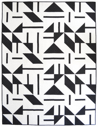 Modern black and white quilt with geometric shapes and precise quilting details, showcasing the Playroom Quilt Pattern (Download) by Sewn for confident beginner quilters.