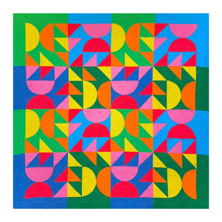 Colorful geometric quilt with bright green, blue, pink, red, yellow, and orange shapes, showcasing the Relative Time Quilt Pattern (Download) by Wood Lily Studio.