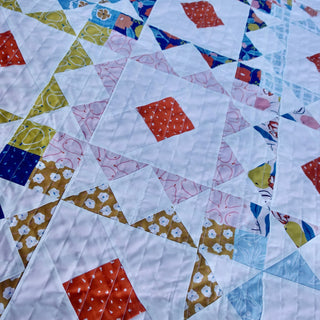 Reverberate Quilt Pattern (Download) by Homemade Emily Jane, a colorful modern geometric quilt with repeating angular shapes and layered patchwork blocks