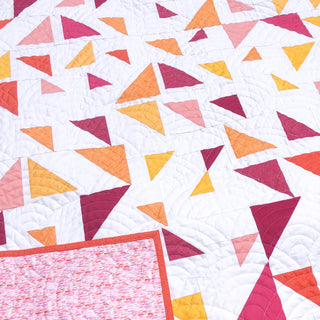 Triangular Quilt Pattern (Download) by Homemade Emily Jane featuring a modern geometric quilt with colorful triangle shapes on a white background