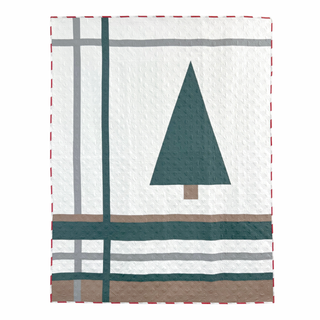 Urban Pine Quilt Pattern by Sew & Sew Quilting Co. cover: white quilt with a dark teal pine tree design and plaid striped border, displayed against a white wall.