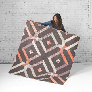 Villager Quilt by Eudaimonia Studio Brown Artist Holding Quilt