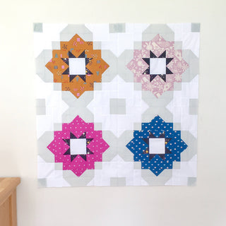 Quilt block featuring colorful geometric designs in orange, pink, blue, and lavender, showcasing the Vintage Tiles Quilt Pattern (Download) by Lou Orth Designs.