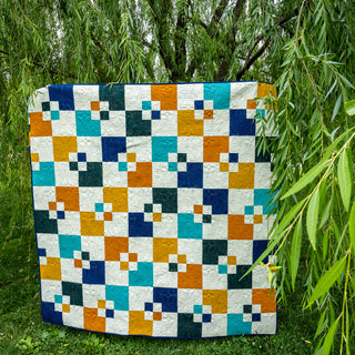 Colorful Welcome Party by Trace Creek Quilting with geometric pattern on grass and trees