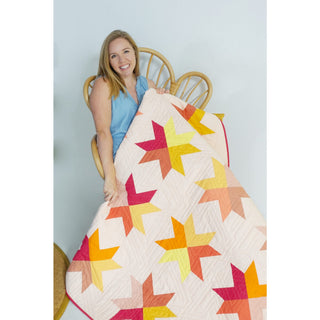 Beaming Quilt Pattern (Download) by Homemade Emily Jane featuring a bright modern star quilt with colorful geometric blocks on a soft white background