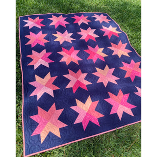 Beaming Quilt Pattern (Download) by Homemade Emily Jane featuring colorful pink star blocks on a deep navy background in a modern quilt design