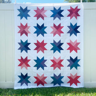Beaming Quilt Pattern (Download) by Homemade Emily Jane featuring colorful modern star quilt blocks in a bold geometric grid on a white background