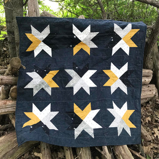 Beaming Quilt Pattern (Download) by Homemade Emily Jane featuring a bold modern star quilt in navy white and golden yellow