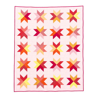 Beaming Quilt Pattern (Download) by Homemade Emily Jane featuring a vibrant modern star quilt with colorful geometric blocks on a pale background