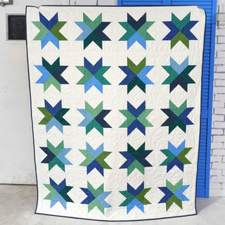 Beaming Quilt Pattern (Download) by Homemade Emily Jane featuring a colorful geometric star quilt with blue and green blocks on a white background