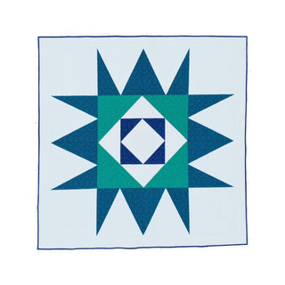 Catalyst Quilt Pattern (Download) by Homemade Emily Jane showing a modern geometric quilt with teal and navy starburst shapes on a pale background