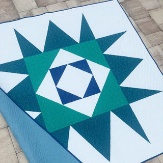 Catalyst Quilt Pattern (Download) by Homemade Emily Jane featuring a modern geometric quilt with bold teal and navy angular shapes on a white background