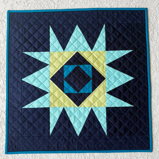 Catalyst Quilt Pattern (Download) by Homemade Emily Jane featuring a modern geometric star quilt with navy teal and lime green contrast