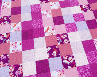 Doubled Up Quilt Pattern (Download) by Homemade Emily Jane featuring a modern geometric patchwork quilt in pink purple and floral fabrics