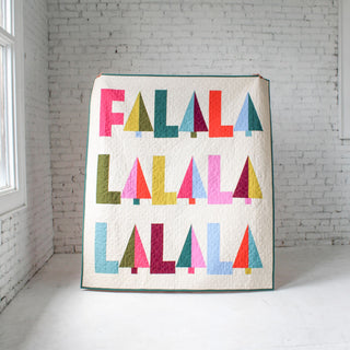 Fa-La-La Quilt Pattern (Download) by Patternly Collective featuring colorful holiday letter blocks in pink teal red yellow and blue