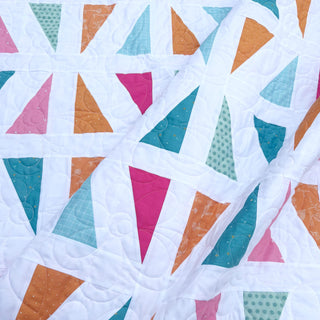 Jubilant Quilt Pattern (Download) by Homemade Emily Jane featuring colorful geometric triangles and bold negative space in a modern quilt design