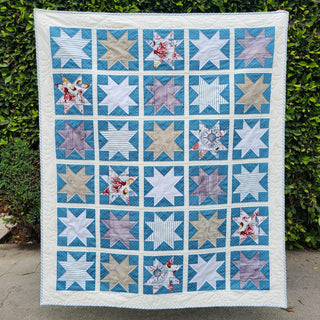 Keepsake Quilt Pattern (Download) by Homemade Emily Jane featuring a modern blue and white star quilt with scrappy geometric blocks and floral accents