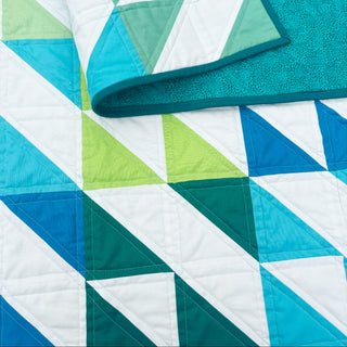 Kinetic Quilt Pattern (Download) by Homemade Emily Jane featuring a modern geometric quilt design in teal blue green and white with dynamic movement